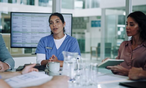 Healthcare and IT professionals discussing navigating compliance and threats in the modern cybersecurity landscape.